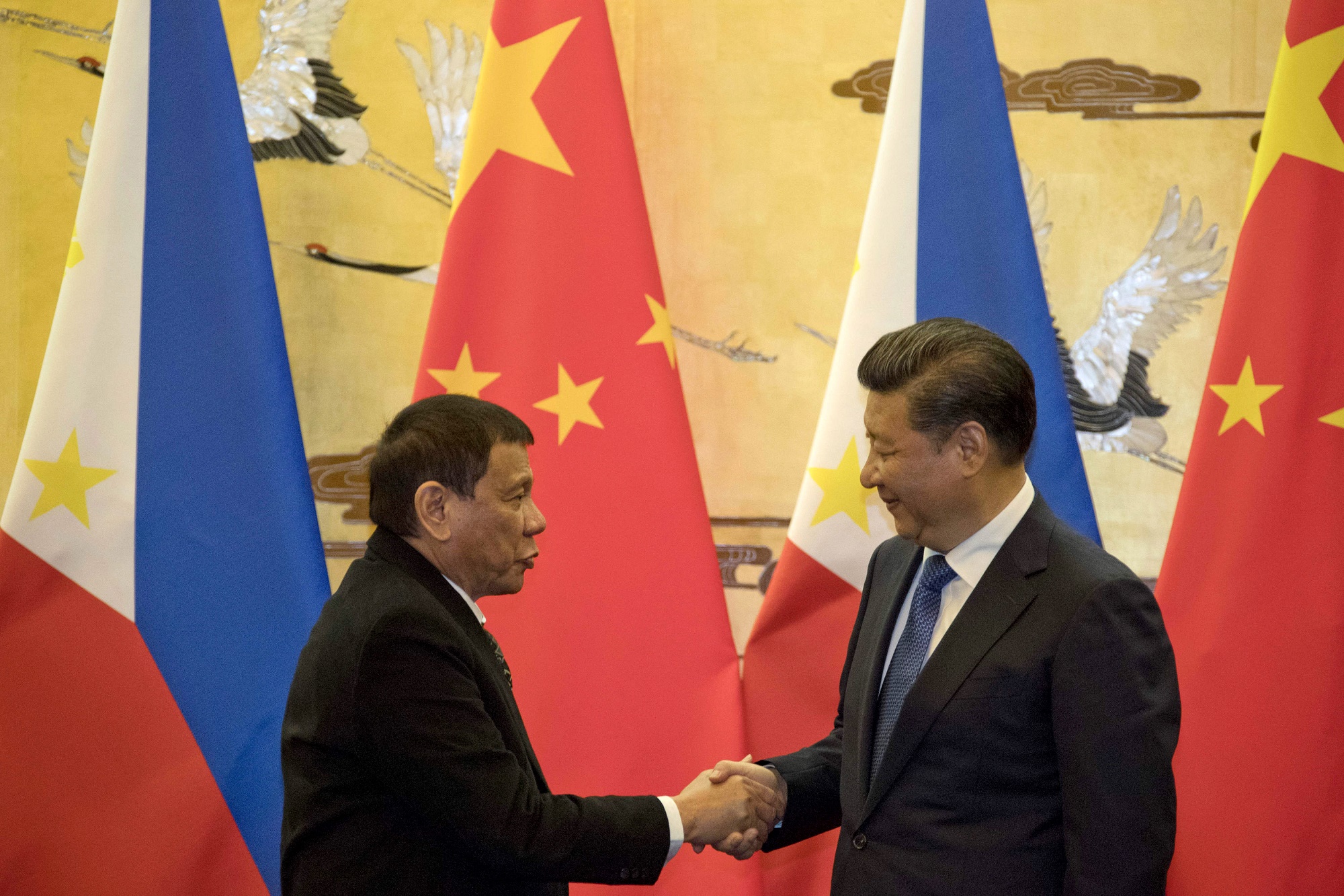 Ông Duterte có xu hướng xích lại gần với Trung Quốc thay vì ngả hẳn theo đồng minh lâu năm là Mỹ. Trong ảnh: Chủ tịch Trung Quốc Tập Cận Bình (phải) và Tổng thống Philippines Rodrigo Duterte (trái) tại cuộc gặp ở Bắc Kinh, Trung Quốc, ngày 20/10/2016. (Nguồn: AFP/TTXVN)