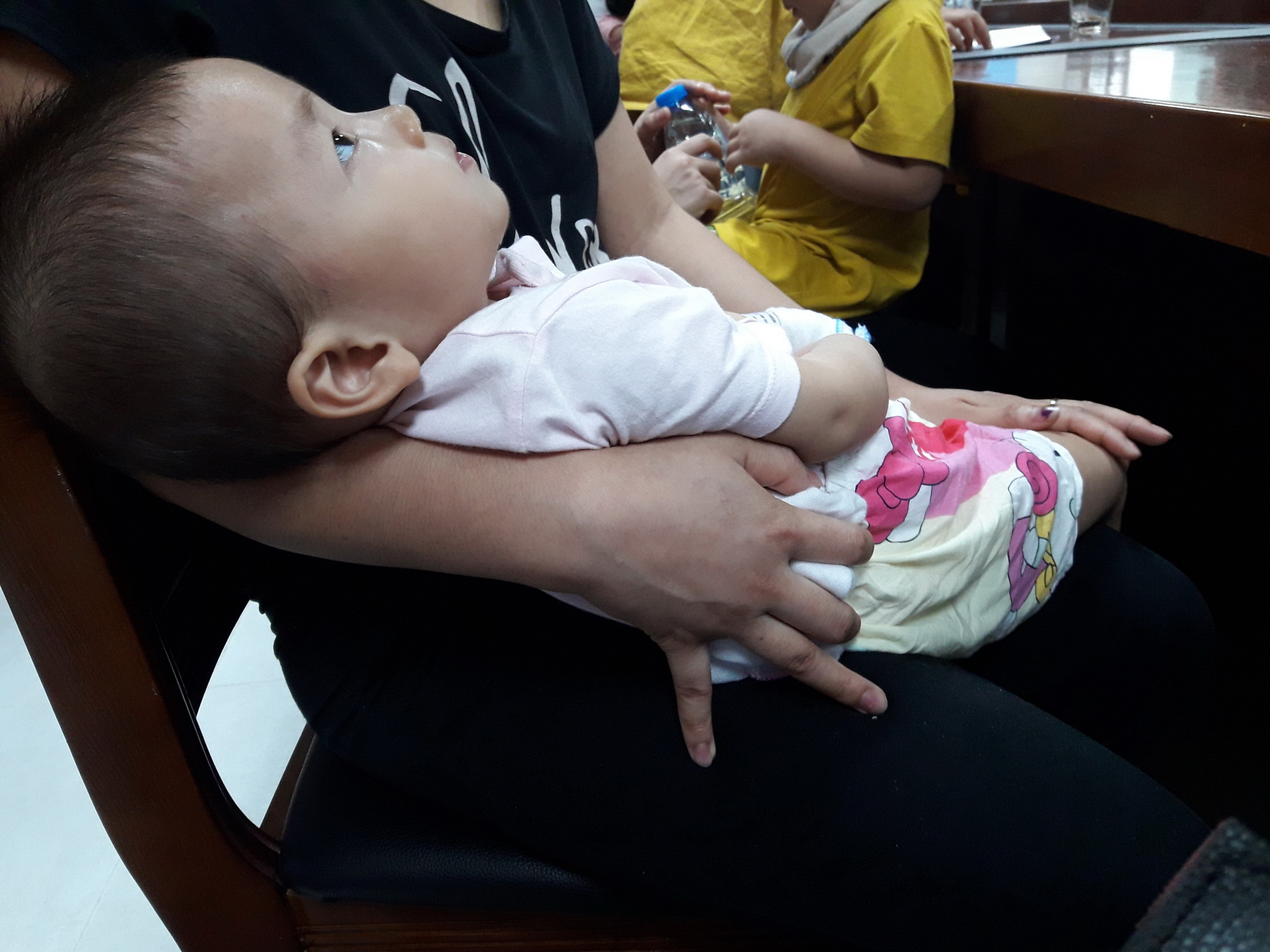 Em bé mắc bệnh rối loạn chuyển hóa bẩm sinh, dù đã 2 tuổi nhưng vẫn chưa biết ngồi. (Ảnh: PV/Vietnam+)