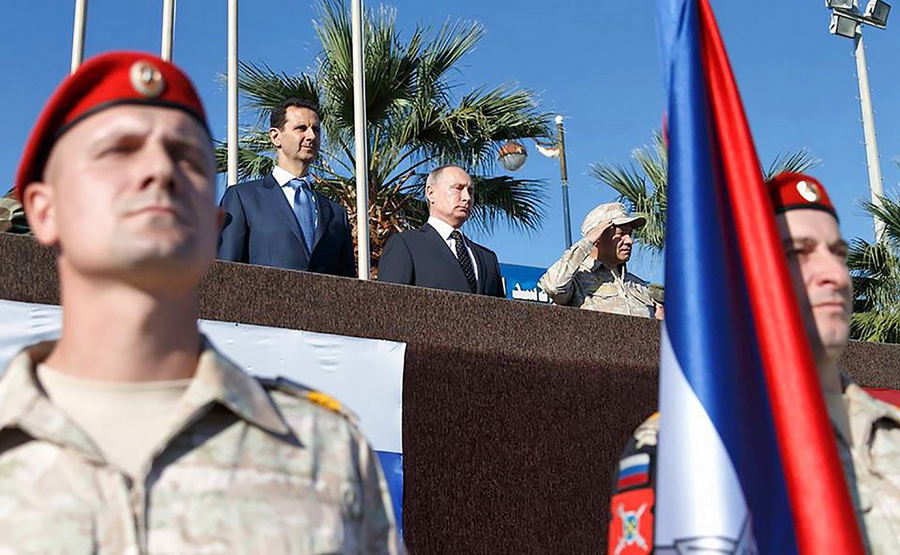 Tổng thống Nga Vladimir Putin (giữa), Tổng thống Syria Bashar al-Assad và Bộ trưởng Quốc phòng Nga Sergei Shoigu tại lễ diễu binh của quân đội Nga ở căn cứ không quân Hmeimim phía Tây Bắc tỉnh Latakia, Syria ngày 11/12. (Nguồn: AFP) 