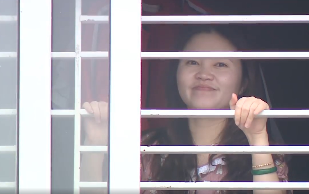 Thuy looks in the direction of her husband from the window of her department. (Photo: VietnamPlus)